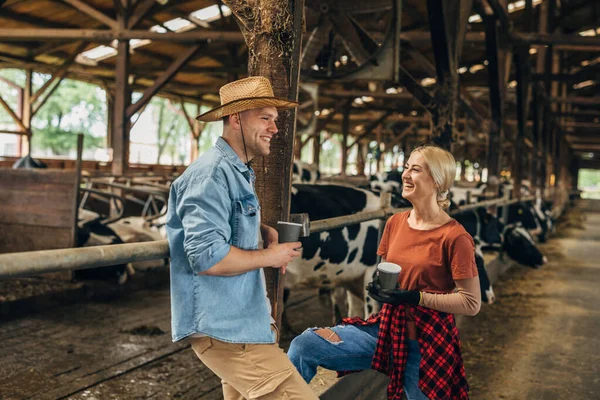 stock image A man and a woman have a nice time taking in a barn.