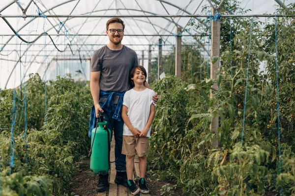 stock image Father and son proudly standing in their vegetable garden.