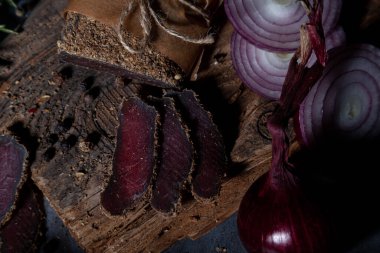 several pieces of thinly sliced dried meat with spices 
