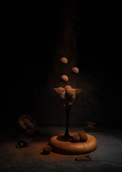 levitation of sweets in a glass glass on a dark background with cocoa and chocolate. Flying food for poster in the kitchen