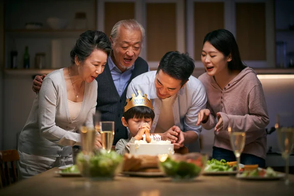 Little Asian Boy Making Wish While Three Generation Family Celebrating — Stock fotografie