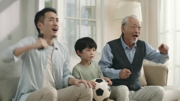Asian Son Father Grandfather Watching Live Broadcasting Football Match Together — 图库视频影像