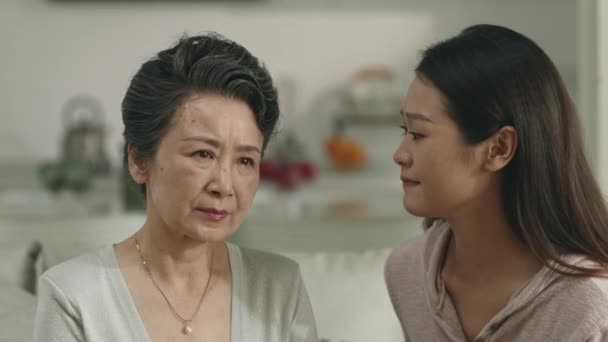 Loving Caring Asian Adult Daughter Consoling Sad Senior Mother Home — Videoclip de stoc