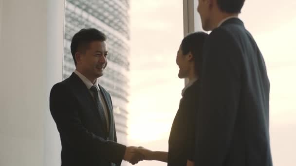 Asijský Manažer Stojící Okna Setkání Dvou Hostujících Zákazníků Moderní Kanceláři — Stock video