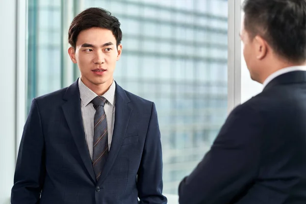 Two Asian Business Men Standing Window Chatting Talking — Stock Photo, Image
