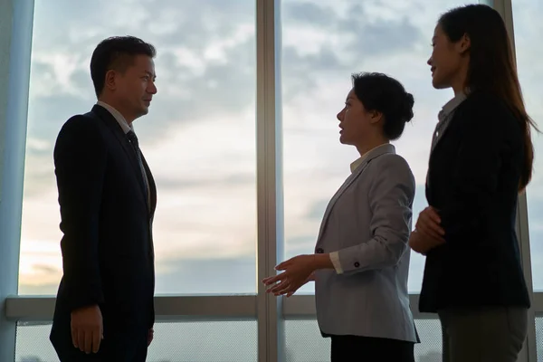 Three Asian Business People Standing Window Office Having Conversation — Stock Photo, Image