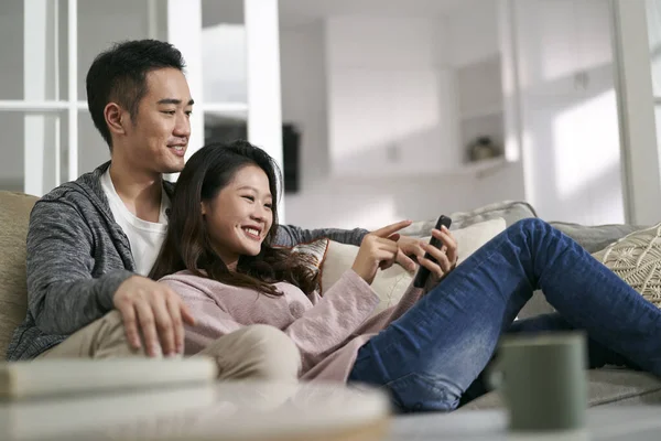 Happy Young Asian Couple Sitting Family Couch Home Looking Cellphone — Stock Photo, Image