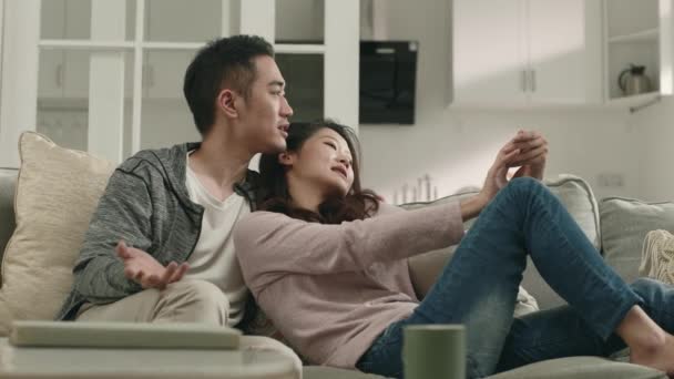 Amando Asiático Casal Sentado Família Sofá Casa Ter Conversa — Vídeo de Stock