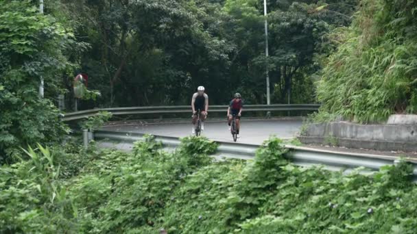 Young Asian Couple Cyclists Riding Bike Rural Road — Stock Video
