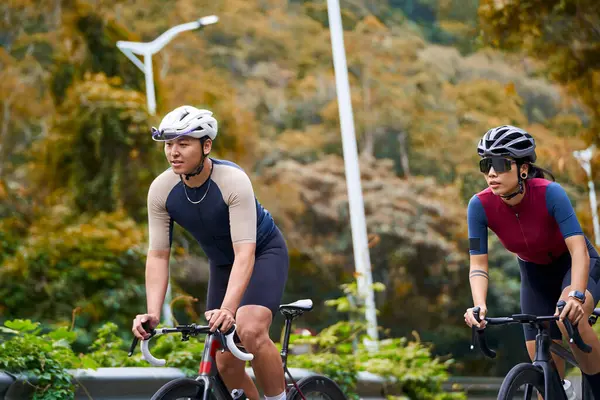 Young Asian Couple Cyclists Riding Bike Rural Road Stock Image