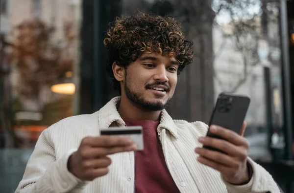 Elinde Kredi Kartı Olan Gülümseyen Yakışıklı Hintli Adam Cep Telefonu — Stok fotoğraf