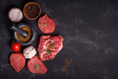 Set of various  raw meat with spices on kitchen table. Top view