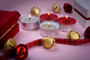 Festive candles on a  table with  decorations.  New Year's or Christmas background.