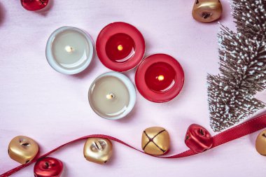 Festive candles on a  table with  decorations.  New Year's or Christmas background.