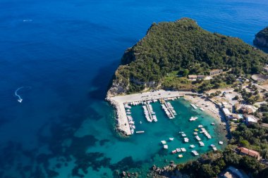 Aerial view of Corfu  marina  in the turquoise sea.  Top view from drone