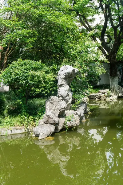 stock image Chinese traditional stone garden. Green plants and rocks