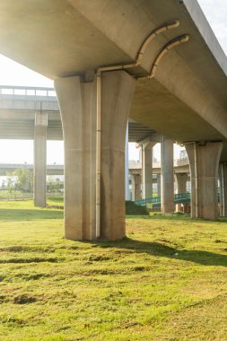 Şehirdeki üst geçidin altında beton yapı ve asfalt yol alanı