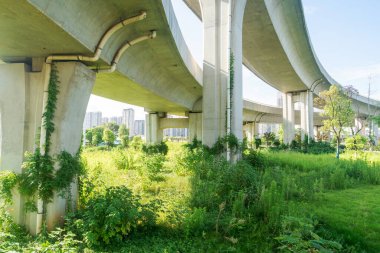 Şehirdeki üst geçidin altında beton yapı ve asfalt yol alanı