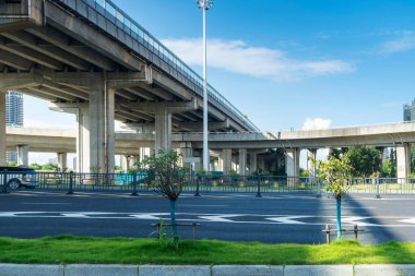 Şehirdeki üst geçidin altında beton yapı ve asfalt yol alanı