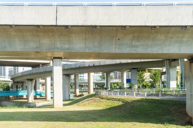 Şehirdeki üst geçidin altında beton yapı ve asfalt yol alanı