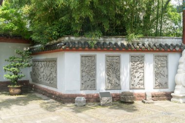 A detailed stone carving decorating a wall in China clipart