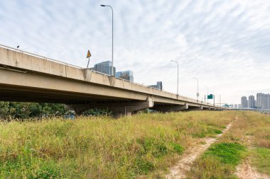 Şehirdeki üst geçidin altında beton yapı ve asfalt yol alanı
