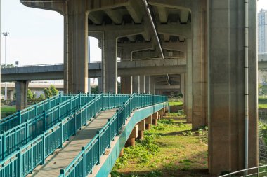 Şehirdeki üst geçidin altında beton yapı ve asfalt yol alanı