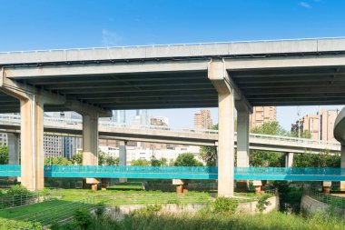 Şehirdeki üst geçidin altında beton yapı ve asfalt yol alanı
