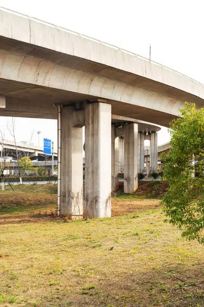 Şehirdeki üst geçidin altında beton yapı ve asfalt yol alanı
