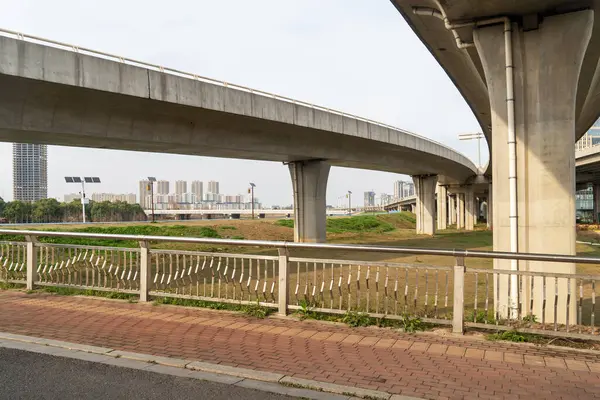 Şehirdeki üst geçidin altında beton yapı ve asfalt yol alanı