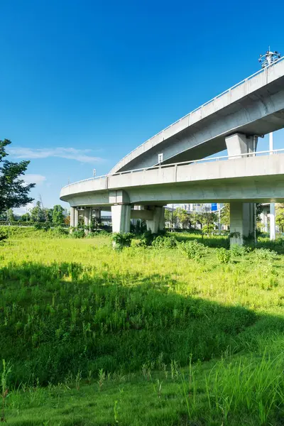 Şehirdeki üst geçidin altında beton yapı ve asfalt yol alanı