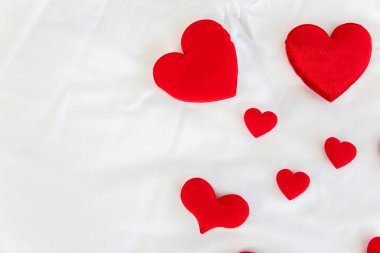 Heart shape with Gift box packed for honeymoon lover on white bed honeymoon suit.Valentine's day concept. Beautiful blurry background.heart lay on the bed.