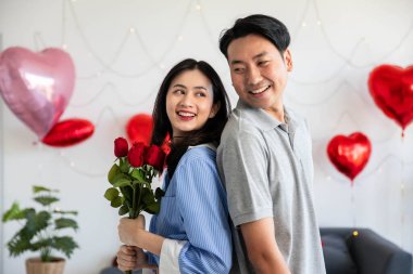 Couple in love hugging in the bedroom with rose and gift Valentine's Day  concept.