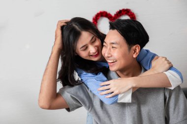 Couple in love hugging in the bedroom with rose and gift Valentine's Day  concept.