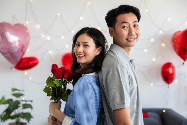 Couple in love hugging in the bedroom with rose and gift Valentine's Day  concept.