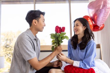 Couple love giving roses to each other on valentines day.
