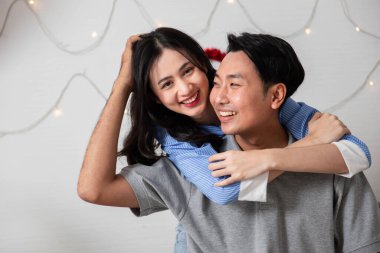 Couple in love hugging in the bedroom with rose and gift Valentine's Day  concept.