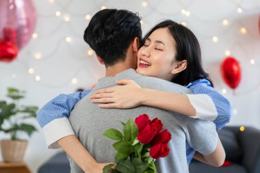 Couple in love hugging in the bedroom with rose and gift Valentine's Day  concept.