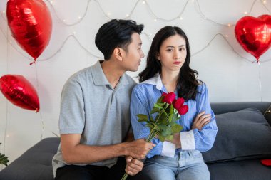 Man with rose  apologize to his girlfriend after they had an argument. Valentine day,