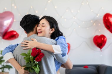 Couple in love hugging in the bedroom with rose and gift Valentine's Day  concept.