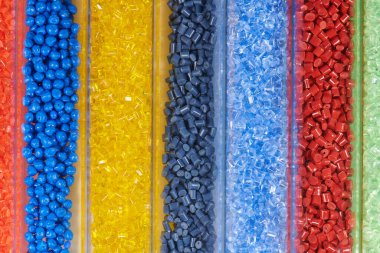 several colored plastic resins in test tubes in laboratory