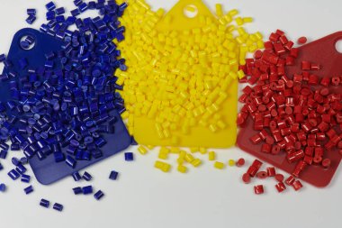 Blue, yellow and red polymer resin granulates