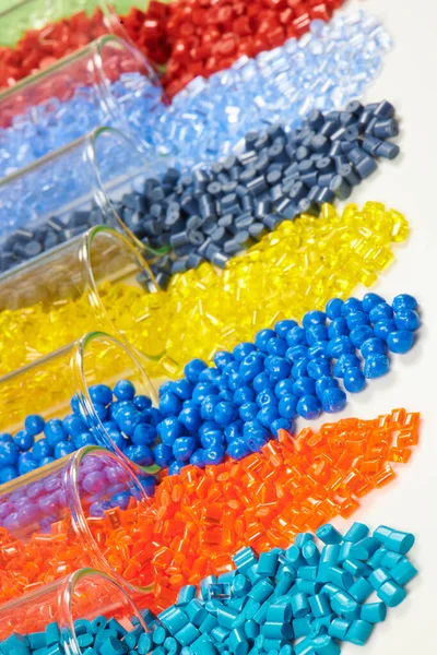 several colored plastic resins in test tubes in laboratory