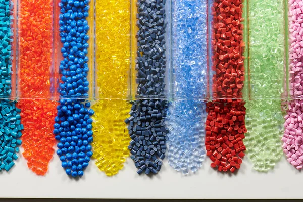 several colored plastic resins in test tubes in laboratory