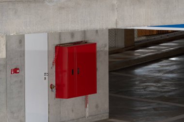 Park yerindeki duvarda asılı bir yangın hortumu.