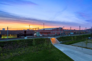 On the railroad tracks with a pedestrian tunnel with a beautiful sunrise