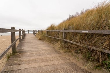 At the dunes of the beach there is this walkway to the beach by the sea