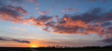 Yel değirmeninin üzerindeki bu güzel renkli bulutlarla güzel bir akşamda