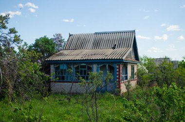 Old abandoned private house in greenery