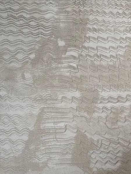 stock image Close-up of a textured concrete surface featuring wavy patterns, showcasing a unique and abstract design